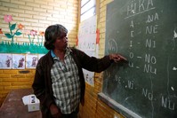 Teacher Blas Duarte shows letters in the Maka language at a school used by children of the Paraguayan ethnic group Maka, in Paraguay.