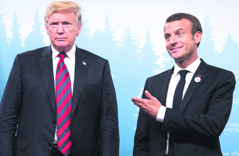 U.S. President Donald Trump and French President Emmanuel Macron hold a meeting on the sidelines of the G-7 Summit in Charlevoix, Quebec, Canada, June 8.