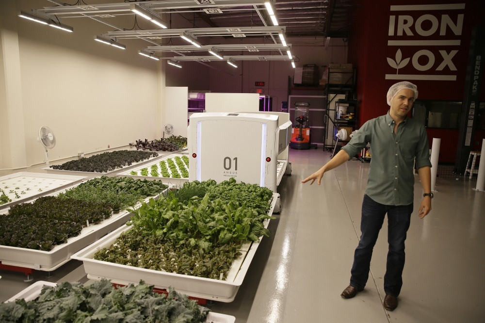 Iron Ox CEO Brandon Alexander gives a tour at his robotic indoor farm in San Carlos, California.
