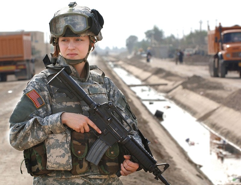 U.S. Army Pfc. Janelle Zalkovsky provides security while other soldiers survey a newly constructed road in Ibriam Jaffes, Iraq, Dec. 4, 2005. (U.S. Army photo)