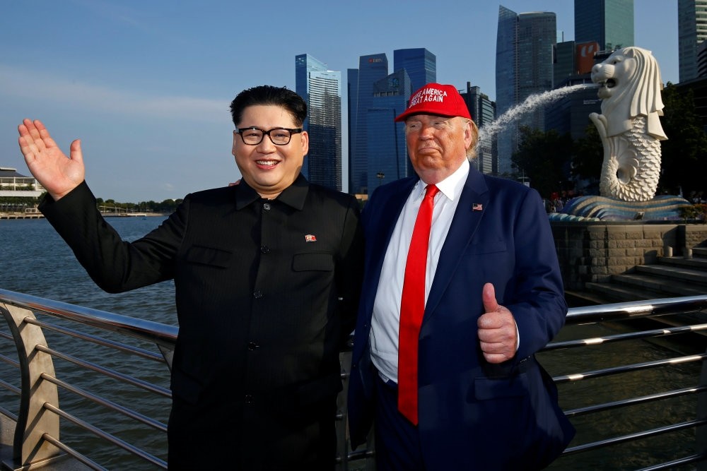 Howard X, an Australian-Chinese impersonating North Korean leader Kim Jong-un, and Dennis Alan, impersonating U.S. President Donald Trump, at Merlion Park in Singapore June 8.