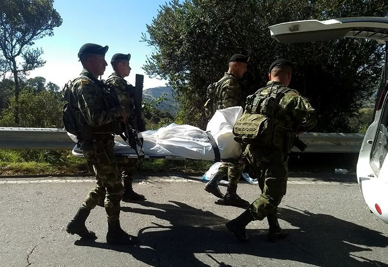 A handout photo made available by the Colombian Army shows soldiers carrying the body of an alleged member of National Liberation Army (ELN) rebel group after clashes (EPA File Photo)