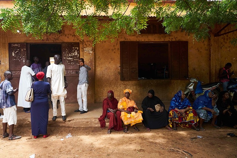 People queue outside to vote at a polling station in Bamako on Aug. 12, 2018 during the second round of Mali's presidential election. (AFP Photo)