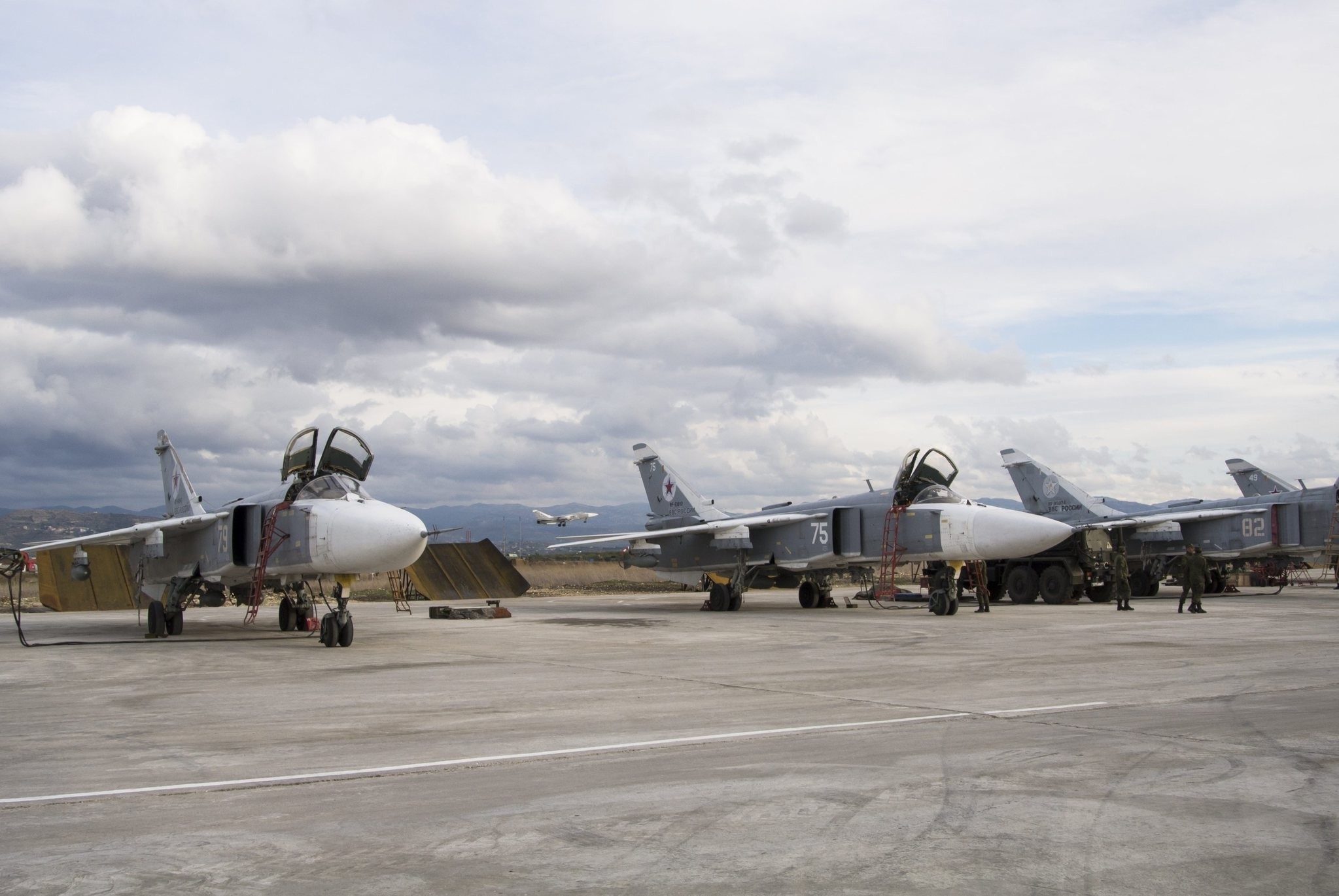 A line-up of Russian bombers stand on tarmac as another plane takes off in the background at Hemeimeem air base in Syria on Wednesday Jan. 20 2016. (AP Photo)