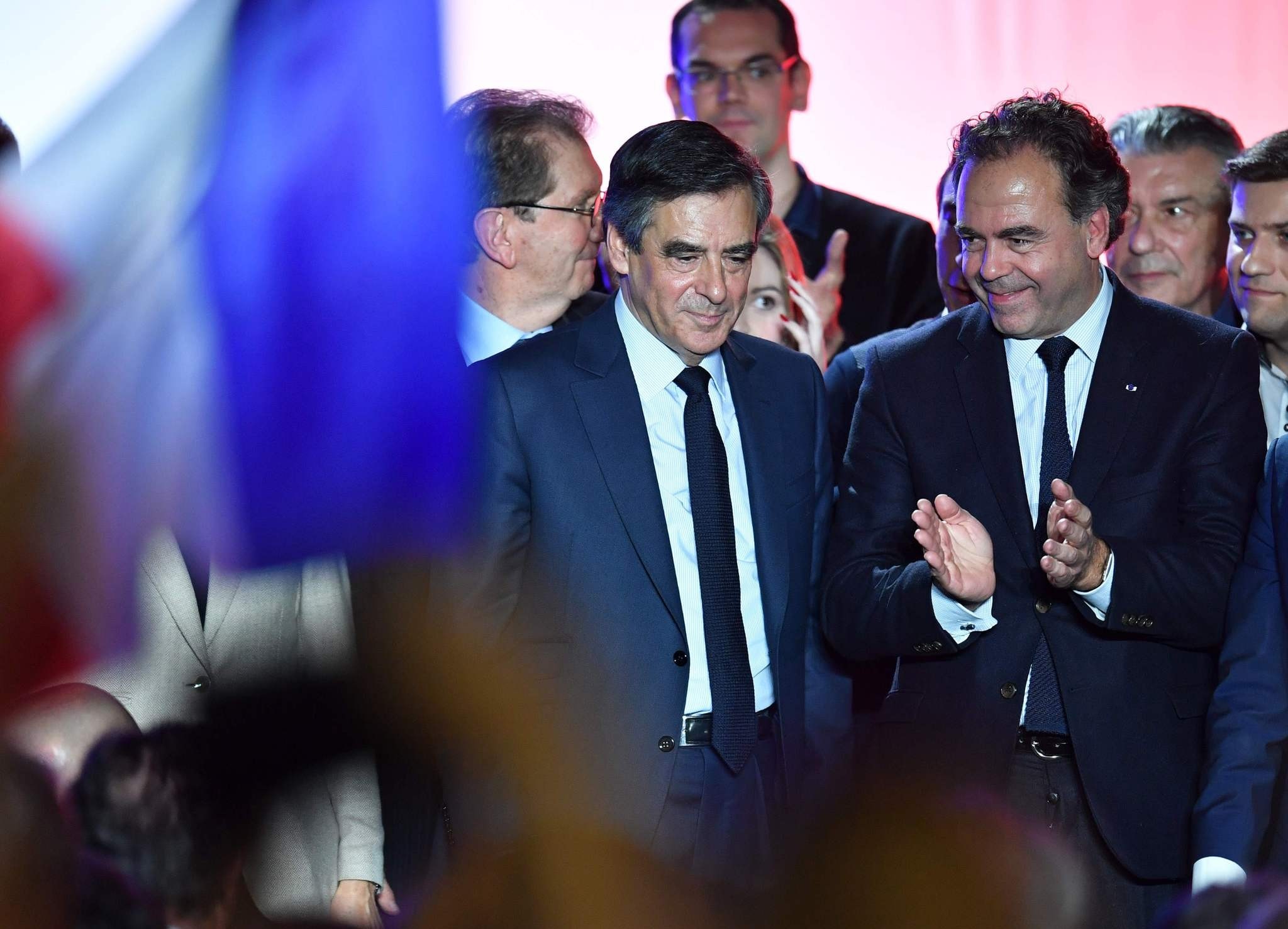 Francois Fillon (L) flanked by French lawmaker Luc Chatel(R) react on March 2, 2017 during a campaign rally on March 2, 2017 in Nu00eemes, southern France. (AFP Photo)