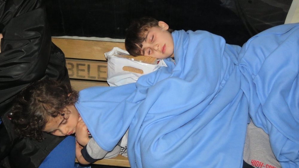  Two children rescued from a migrant boat that sank off the Turkish coast sleep on a bench at the Ku00fcu00e7u00fckkuyu port they were taken to in February.