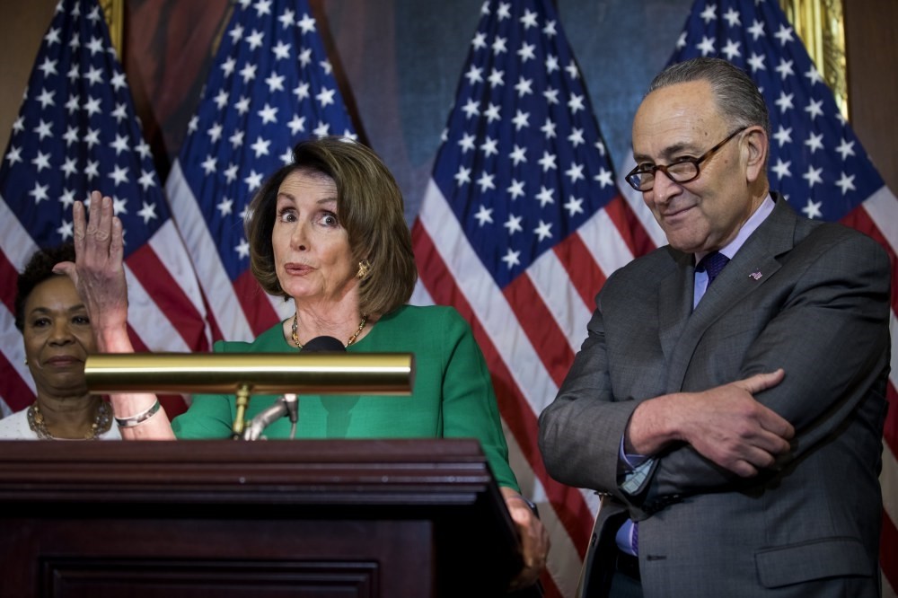Democratic House Minority Leader from California Nancy Pelosi (L) and Democratic Senate Minority Leader Chuck Schumer (R), along with other lawmakers, speak about President Trump's first 100 days in Washington.