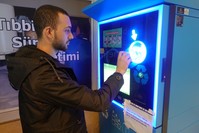 A man deposits a plastic bottle into Istanbul municipality's reverse vending machine, Feb. 28, 2019. 