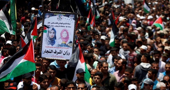 Mourners attend the funeral of Palestinian nurse Razan Al-Najar, who according to health officials and a witness was killed by Israeli forces as she tried to help a wounded protester at the Gaza border, on June 2, 2018. (Reuters Photo)