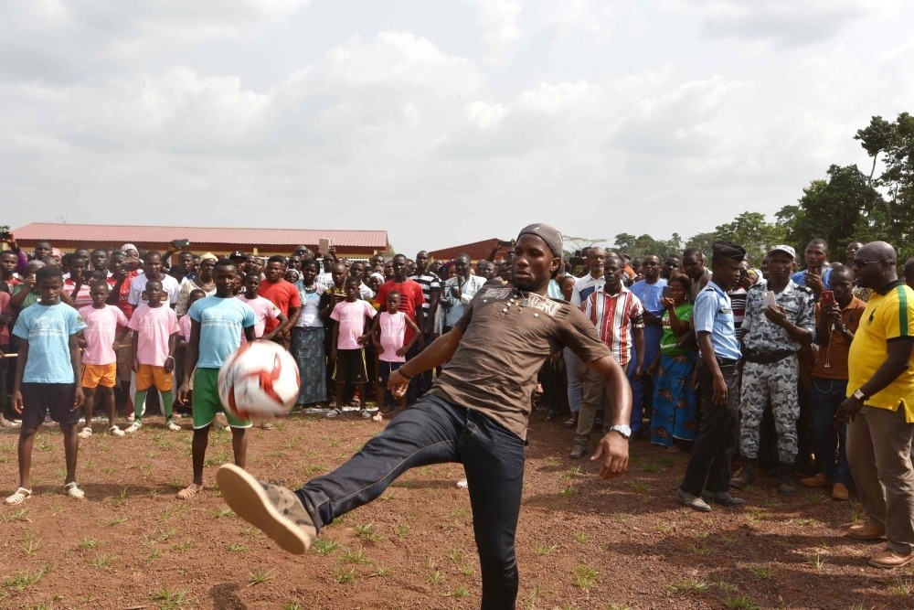 Ivory Coast's football star Didier Drogba plays with a ball on the football ground of the Primary School Didier Drogba during its inauguration on Friday in Pokou-Kouamekro, near Gagnoa, central-western Ivory Coast.
