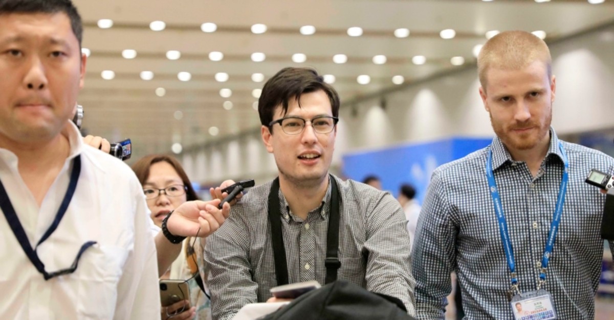Australian student Alek Sigley smiles as he arrives at the airport in Beijing on Thursday, July 4, 2019. (Kyodo News via AP)
