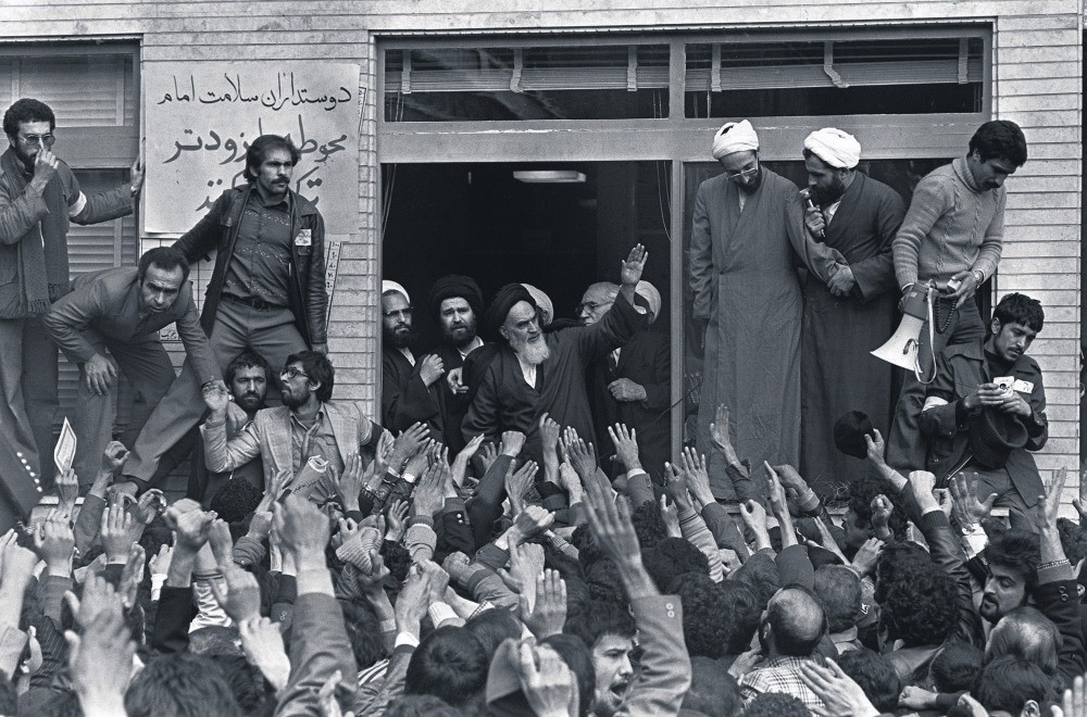 Ayatollah Ruhollah Khomeini waves to his followers on the balcony of his headquarters in Tehran following his arrival in the country as part of a revolution against the Iranian government, Feb. 1, 1979.
