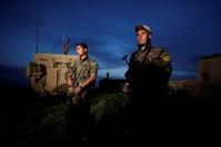 Fighters from the People's Protection Units (YPG) terrorist group stand near a U.S military vehicle in the town of Darbasiya near the Turkish border, Syria April 28, 2017. (Reuters Photo)
