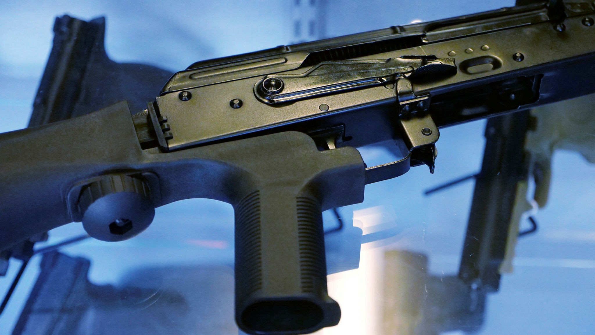 In this Oct. 4, 2017, file photo, a device called a ,bump stock, is attached to a semi-automatic rifle at the Gun Vault store and shooting range in South Jordan, Utah. (AP Photo)