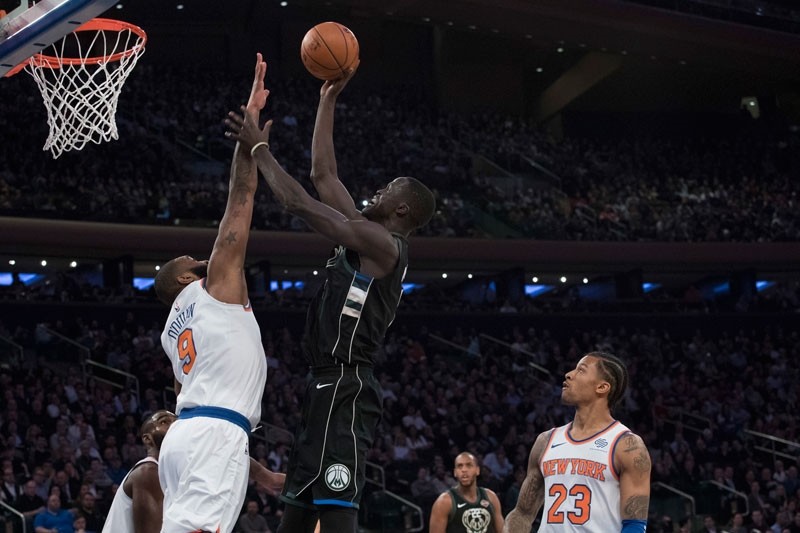 Milwaukee Bucks center Thon Maker, center. goes to the basket against New York Knicks center Kyle O'Quinn (9) during the first half of an NBA basketball game Tuesday, Feb. 6, 2018, at Madison Square Garden in New York. (AP Photo)
