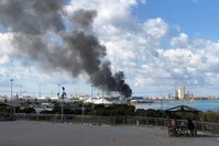 A smoke rises from a port of Tripoli after being attacked in Tripoli, Feb. 18, 2020. REUTERS