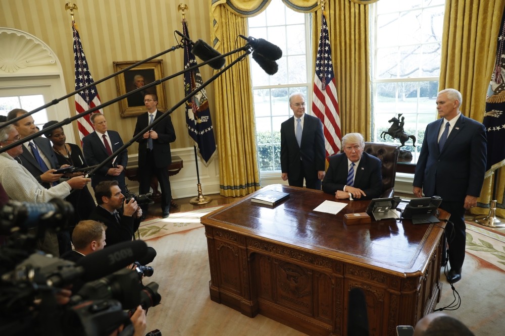 Trump, accompanied by Secretary of Health and Human Services Tom Price (L) and Vice President Mike Pence (R), meeting with members of the media in the Oval Office of the White House, Washington D.C., March 24. (AP Photo)