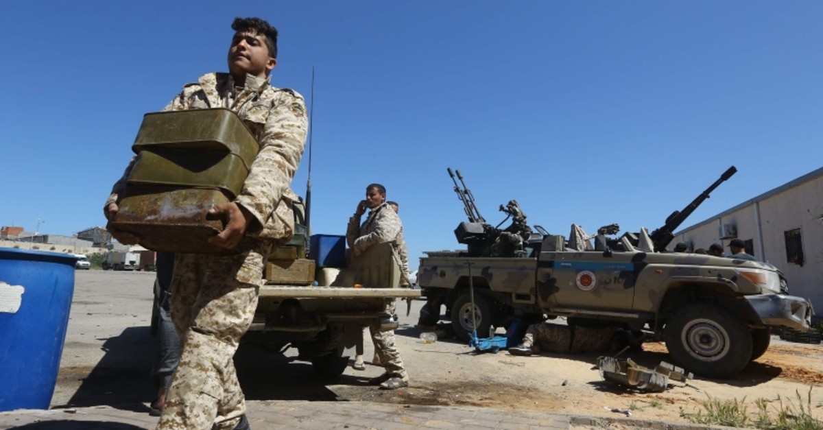 Fighters from a Misrata armed group loyal to Libyan Government of National Accord (GNA) prepare their ammunition before heading to the on April 9, 2019. (AFP Photo)