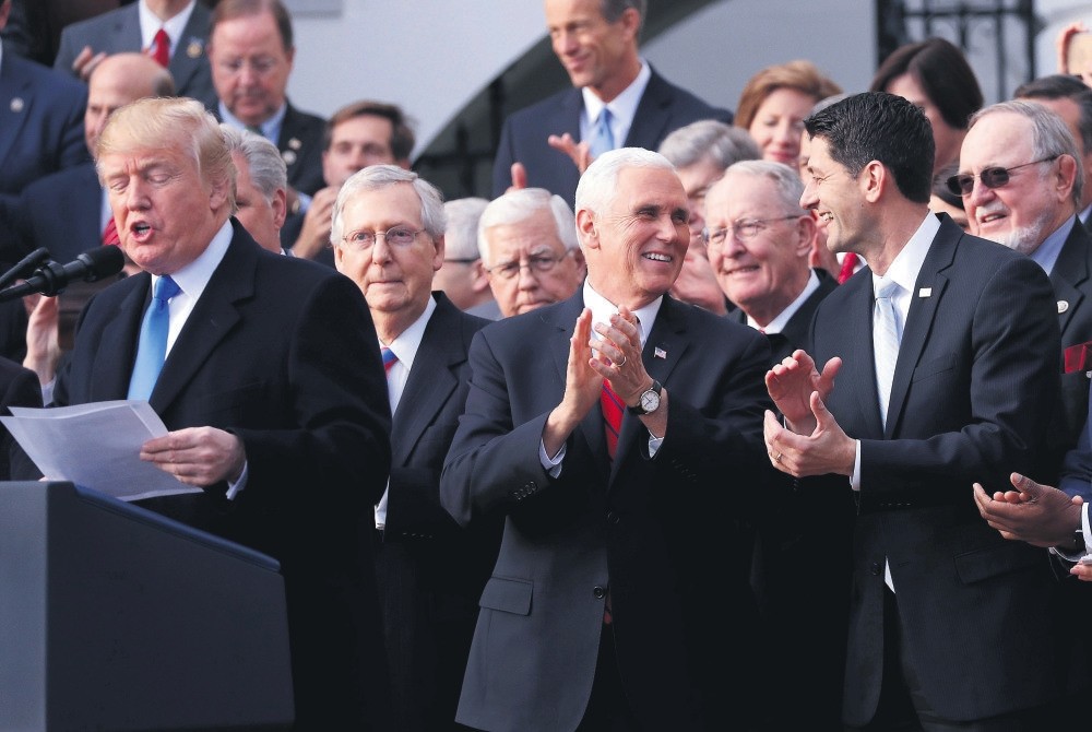 President Trump (L) celebrates with Congressional Republicans after Congress passed sweeping tax overhaul legislation, the White House, Washington, Dec. 20. 