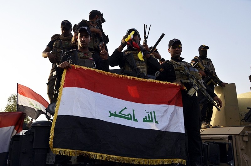 Iraqi soldiers carry the Iraq flag in formation during - NARA
