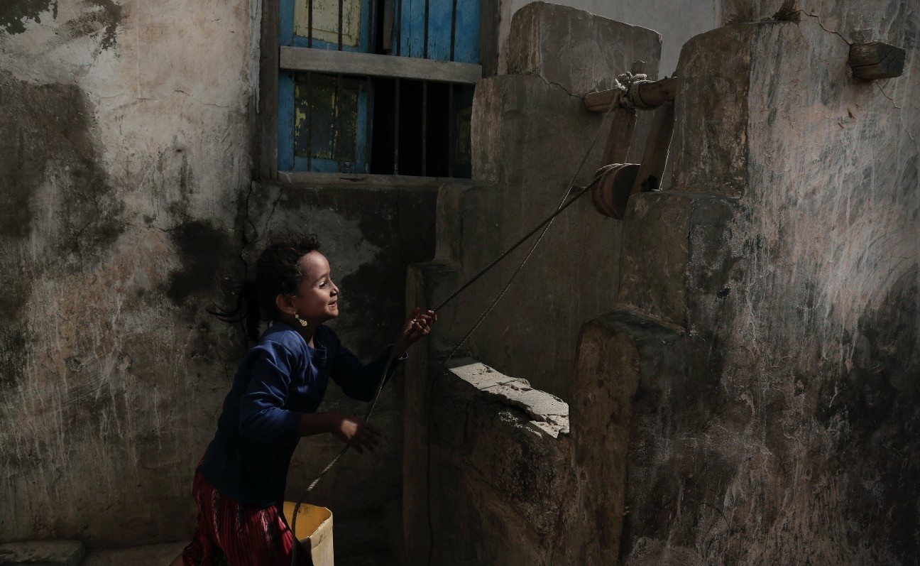 A girl draws water from a well at her home in al-Khoukha, Yemen, Feb. 12.