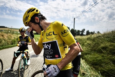 Great Britain's Geraint Thomas cleans his eyes after tear gas was used during a farmers' protest who attempted to block the stage's route during the Tour de France cycling race on July 24, 2018. (AFP Photo)
