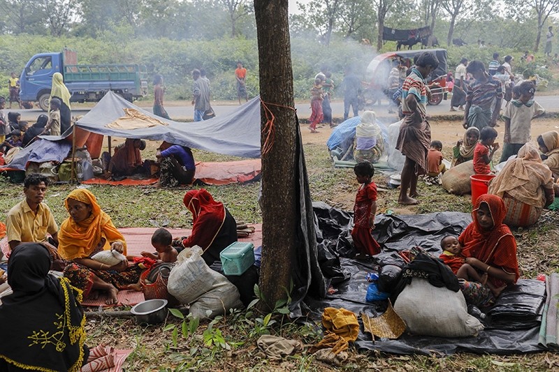 Newly arrived Rohingya refugees rest on the roadside after fleeing to Bangladesh from Myanmar in Ukhiya on Sept. 6, 2017. (AFP Photo)