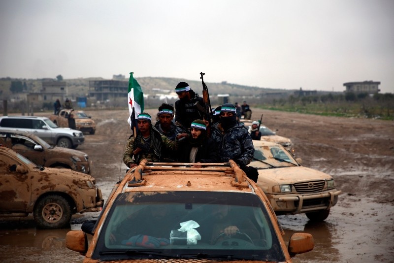 This Dec. 25, 2018 photo shows the Free Syrian Army (FSA) fighters in the back of their trucks as they leave their barracks in the town of Jarabulus, as they prepare to move towards Manbij. (AFP Photo)
