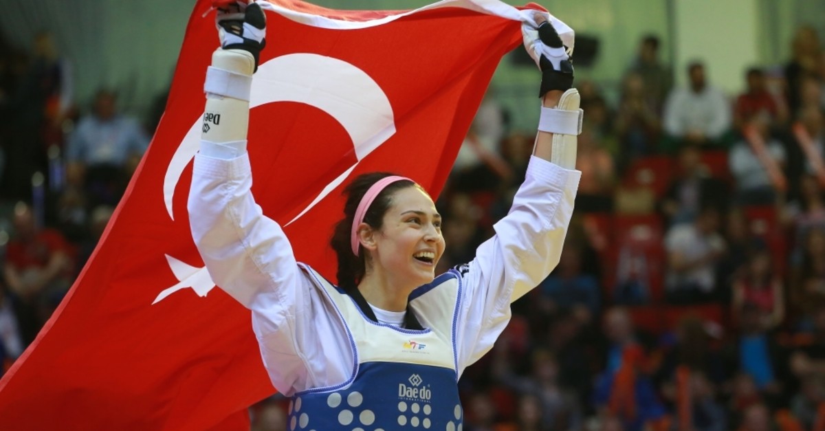 u0130rem Yaman carries the Turkish flag as she celebrates her win at the World Taekwondo Championship in Russia, May 2018.