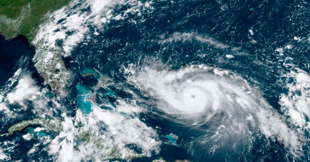 This GOES-16 satellite image taken Friday, Aug. 30, 2019, at 17:20 UTC and provided by National Oceanic and Atmospheric Administration (NOAA), shows Hurricane Dorian, right, moving over open waters in the Atlantic Ocean. (NOAA via AP)