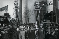 Demonstrators with Stem Masks, Leningrad, May 1, 1924. On the left side of the mask, the slogan- ,I'm buying from a private seller, on the right- ,I consume cooperative goods, Krasnaya Gazeta, May 2, 1925.