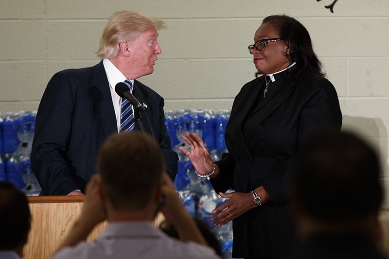 Rev. Faith Green Timmons interrupts Republican presidential candidate Donald Trump as he spoke during a visit to Bethel United Methodist Church, Wednesday, Sept. 14, 2016, in Flint, Mich. (AP Photo)