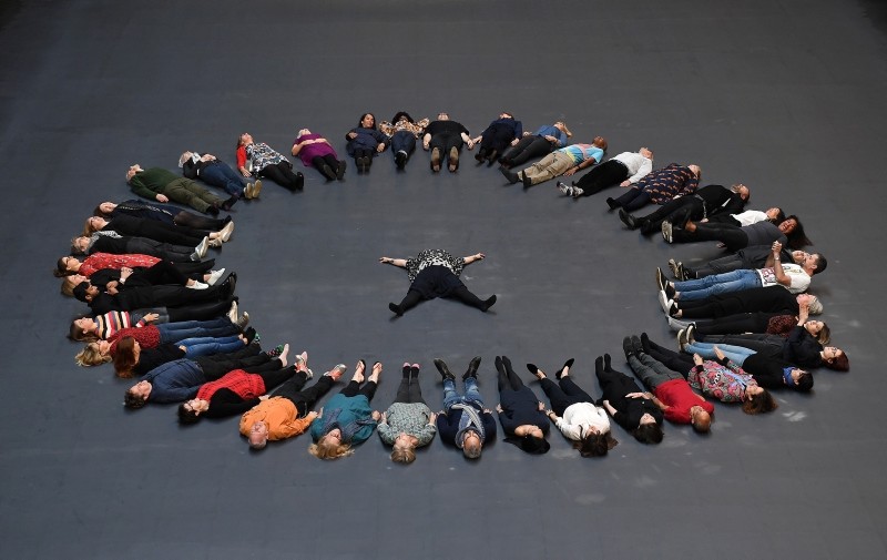  Cuban artist and activist Tania Bruguera (C) lies with volunteers on her installation during its unveiling in the Turbine Hall at Tate Modern in London, Britain, October 1, 2018. (EPA Photo)