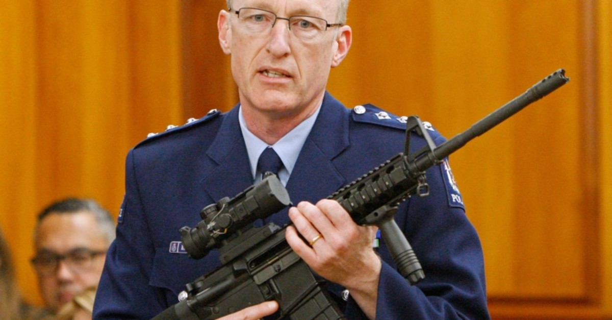 In this April 2, 2019 photo, police acting superintendent Mike McIlraith shows lawmakers in Wellington,an AR-15 style rifle similar to a weapon a gunman used to slaughter 51 people in Christchurch. (AP Photo)
