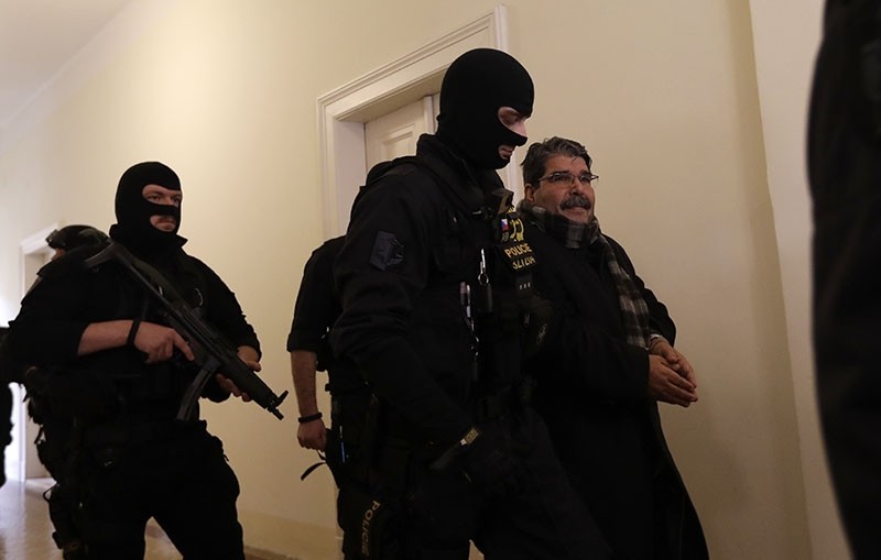 Policemen escort Salih Muslim, former co-chair of the PKK-linked Democratic Union Party, or PYD, to a court room for a custody hearing in Prague, Czech Republic, Tuesday, Feb. 27, 2018. (AP Photo/Petr David Josek)