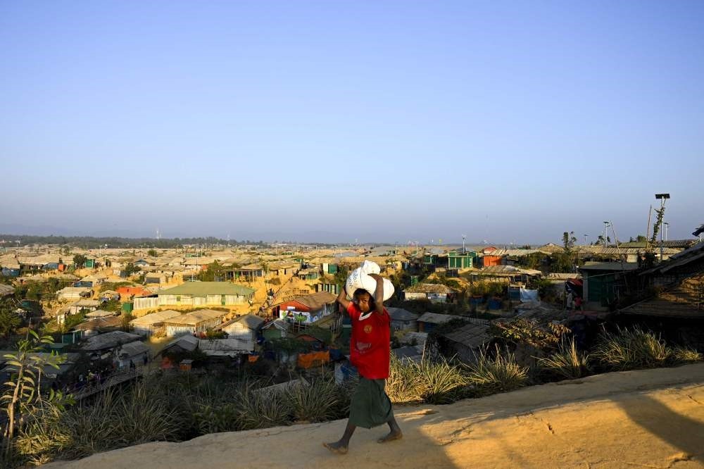A young Rohingya refugee walks back home at the Balukhali refugee camp, Ukhia, Feb. 4, 2019.