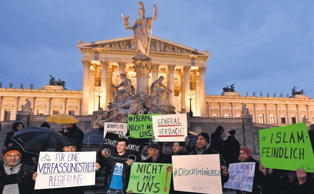 Protesters hold banners during a demonstration organized under the slogan New Islam Law? Not with us! in front of the parliament building in Vienna, Austria, Feb. 24, 2015.