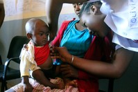 In this photo taken on Thursday, March 21, 2019, a volunteer nurse examines 6-moth-old Sarobidy, who is infected with measles, while her mother Nifaliana Razaijafisoa looks on, at a healthcare centre in Larintsena, Madagascar. (AP Photo)