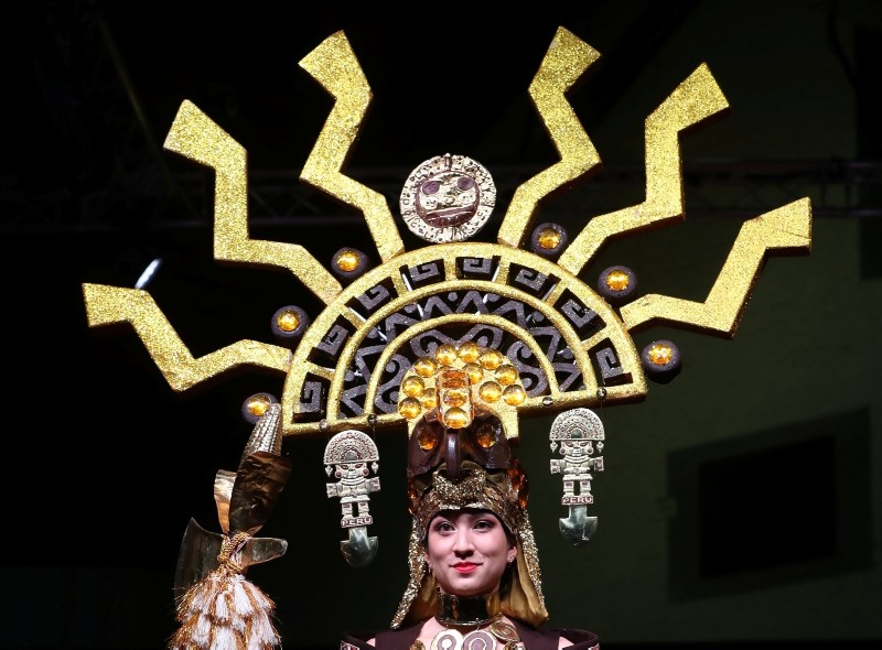 A model dressed in an outfit made with chocolate presents a creation at the 