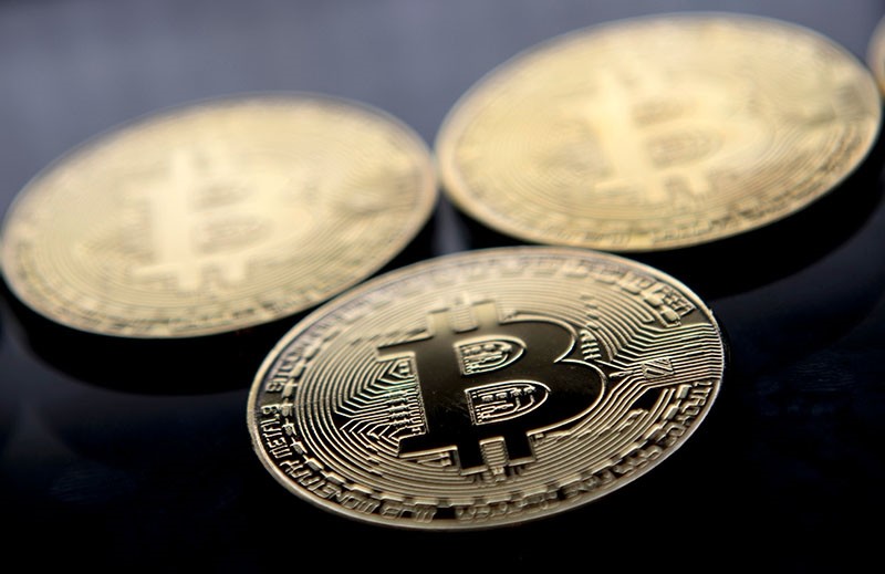 This file photo taken on November 20, 2017 shows gold plated souvenir Bitcoin coins arranged for a photograph in London. (AFP Photo)
