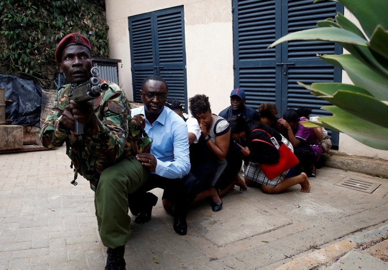 People are evacuated by a member of security forces at the scene where explosions and gunshots were heard at the Dusit hotel compound, in Nairobi, Kenya Jan. 15, 2019. (Reuters Photo)