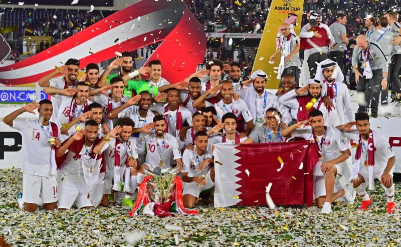 Players and teammembers of Qatar celebrate with trophy after winning the AFC Asian Cup final match between Japan and Qatar in Zayed Sport City in Abu Dhabi, United Arab Emirates, Friday, Feb. 1, 2019. (AP Photo)