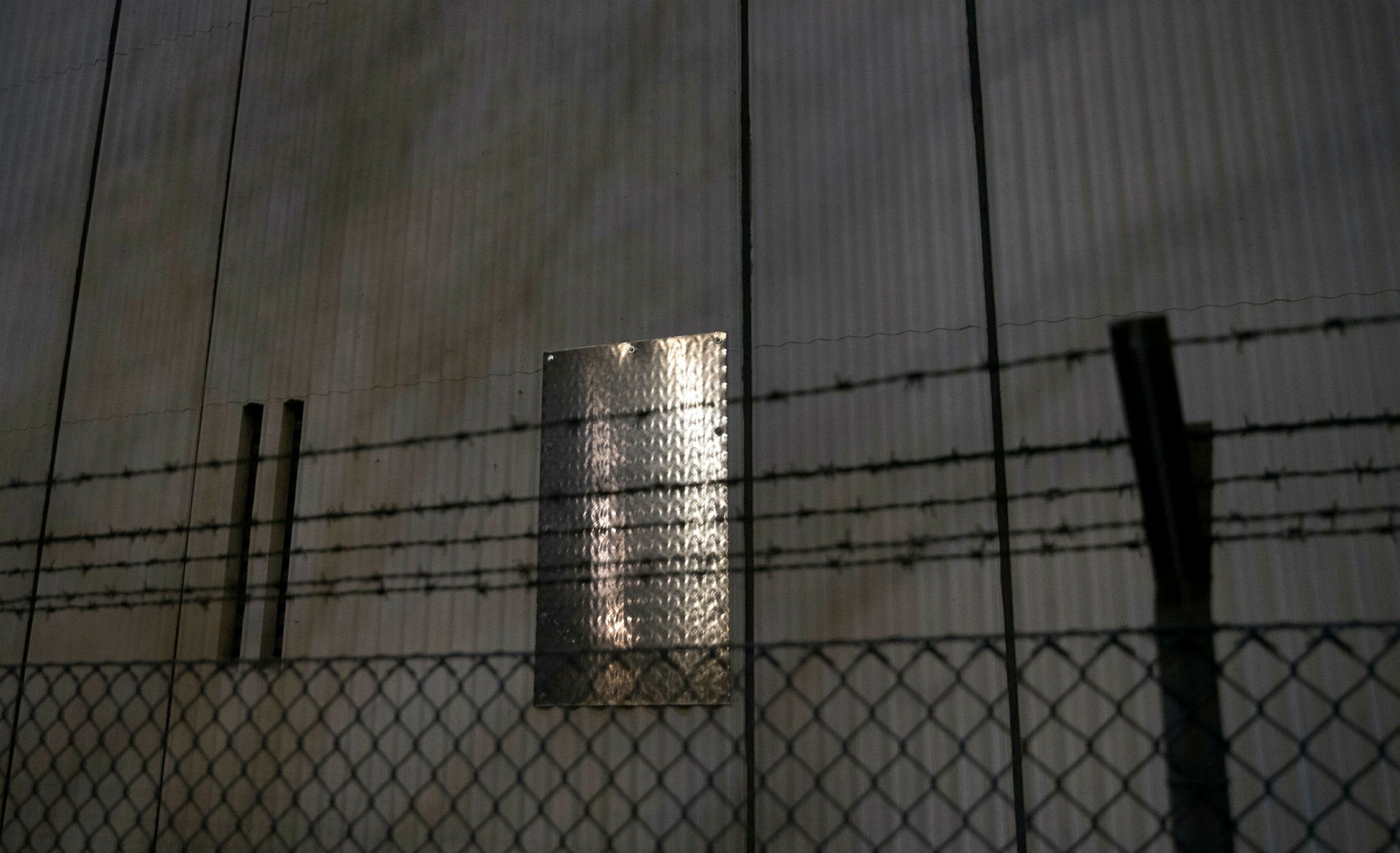 A metal plate is fixed on a hole in the wall of the car workshop's boiler room of Ploetzensee prison in Berlin, Germany, 01 January 2018. (EPA Photo)