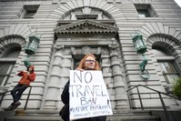 Author Beth Kohn protests against the travel ban, outside the 9th U.S. Circuit Court of Appeals courthouse in San Francisco.