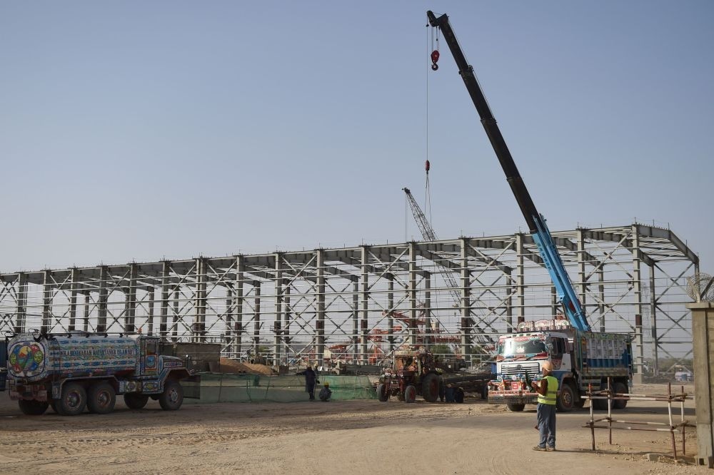 Pakistani workers at a Chinese-backed power plant under construction in Islamkot in the desert in the Tharparkar district of Pakistan's southern Sindh province, May 23.