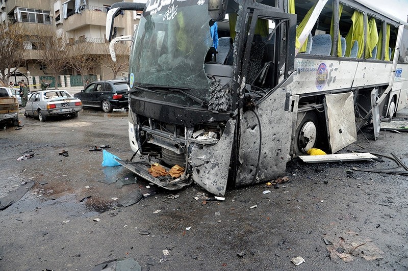 A handout photo made available by the Syrian Arab News Agency (SANA) shows a damaged bus at the site of bombing, in Damascus, Syria on March 11, 2017. (EPA Photo)