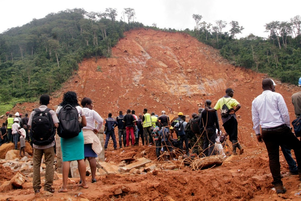 Volunteers stand at the scene of heavy flooding and mudslides in Regent, just outside of Sierra Leone's capital Freetown. (AP Photo)