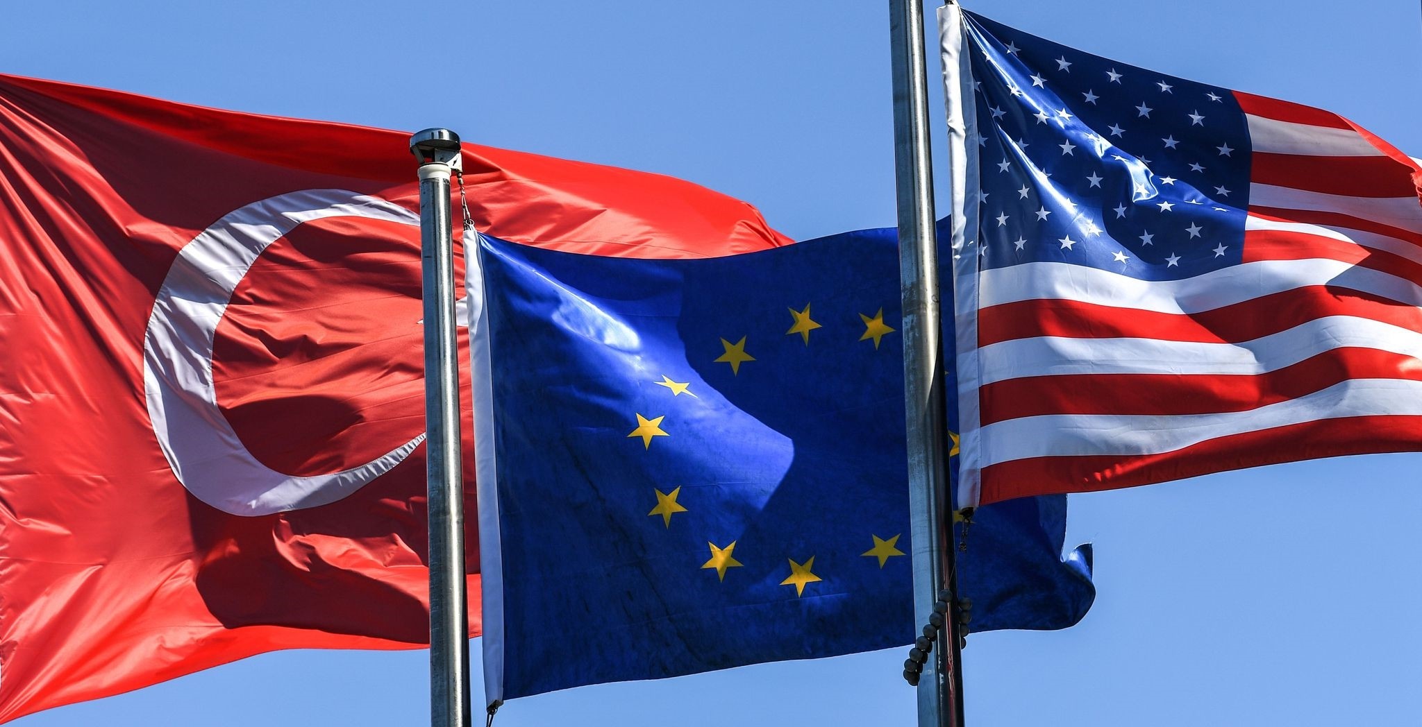 (From L) The Turkish flag, the European Union flag and the U.S. flag float in the wind in the financial and business district of Maslak, Istanbul, Aug. 15.