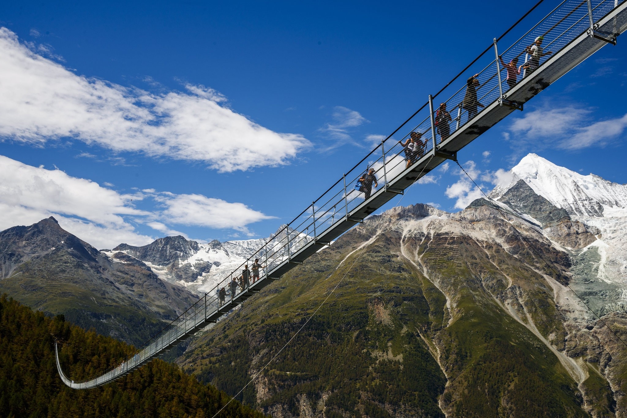 People walk on the 'Europabruecke' bridge, the world's longest pedestrian suspension bridge with a length of 494m, after the official inauguration of the construction in Switzerland, 29 July 2017. (EPA Photo)