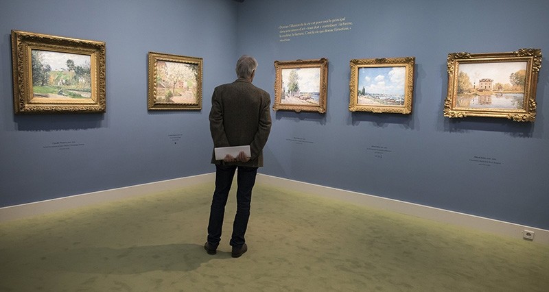 A visitor looks at paintings as part of the 'Secret Garden of the Hansens: The Ordrupgaard Collection' exhibition held at the Jacquemart-Andre museum in Paris (EPA Photo)
